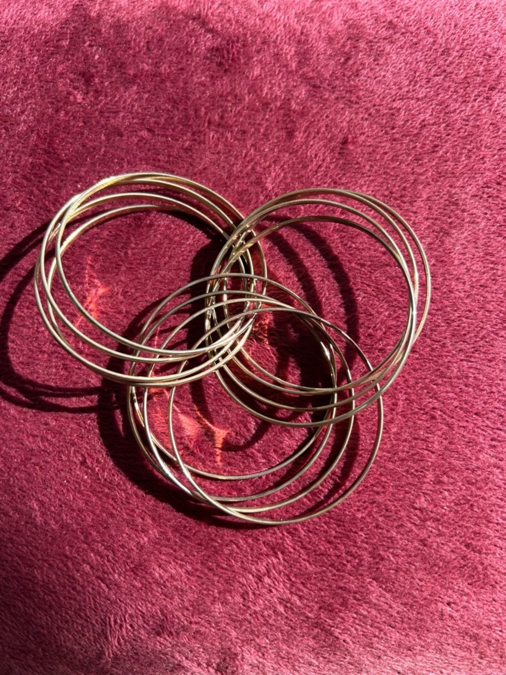 Gold-tone stackable bangles are designed for a minimalist, timeless look.